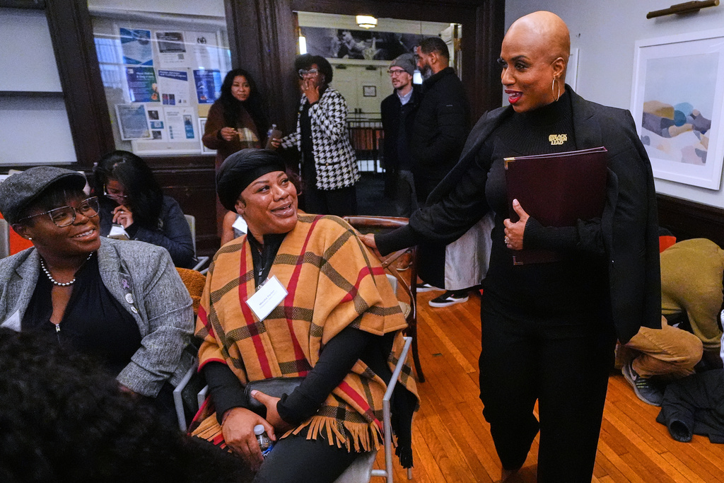 U.S. Rep. Ayanna Pressley, D-Mass., right, greets guests while arriving for a roundtable meeting, Monday, Nov. 24, 2025, in Boston. (AP Photo/Charles Krupa)