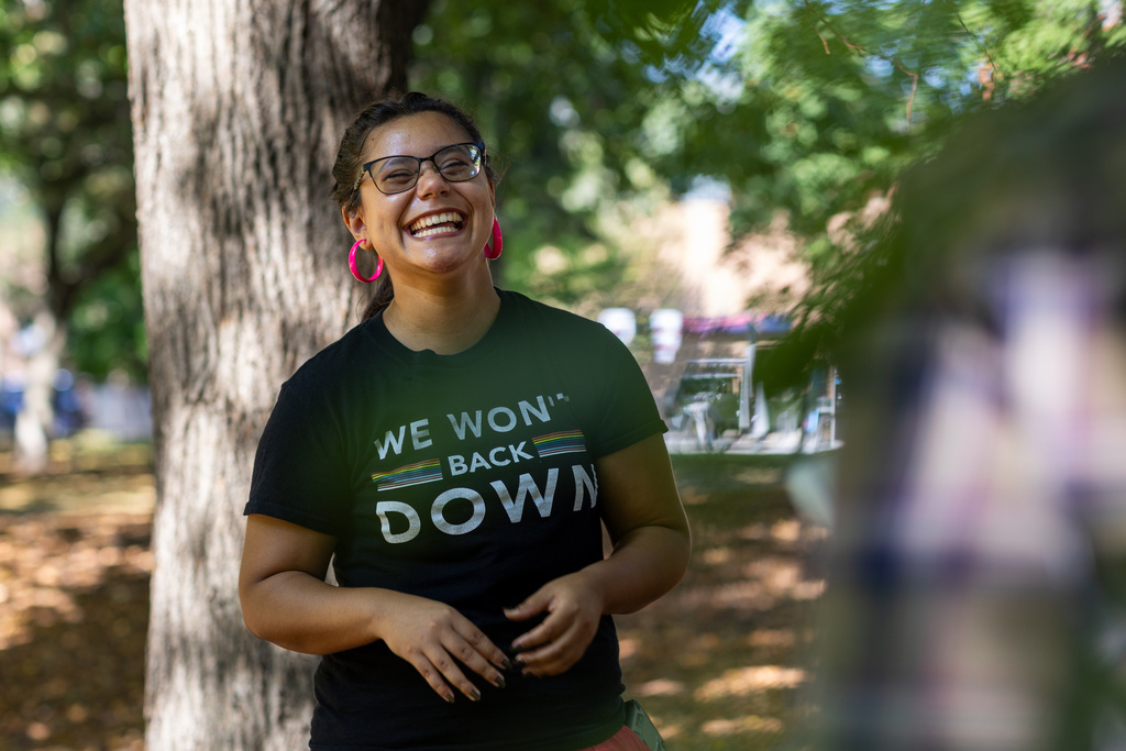 DePaul University senior Maya Roman, 22, president of a student reproductive health group, smiles while speaking to fellow members at Oz Park in Chicago on Sunday, Sept. 28, 2025. (AP Photo/Heidi Zeiger)