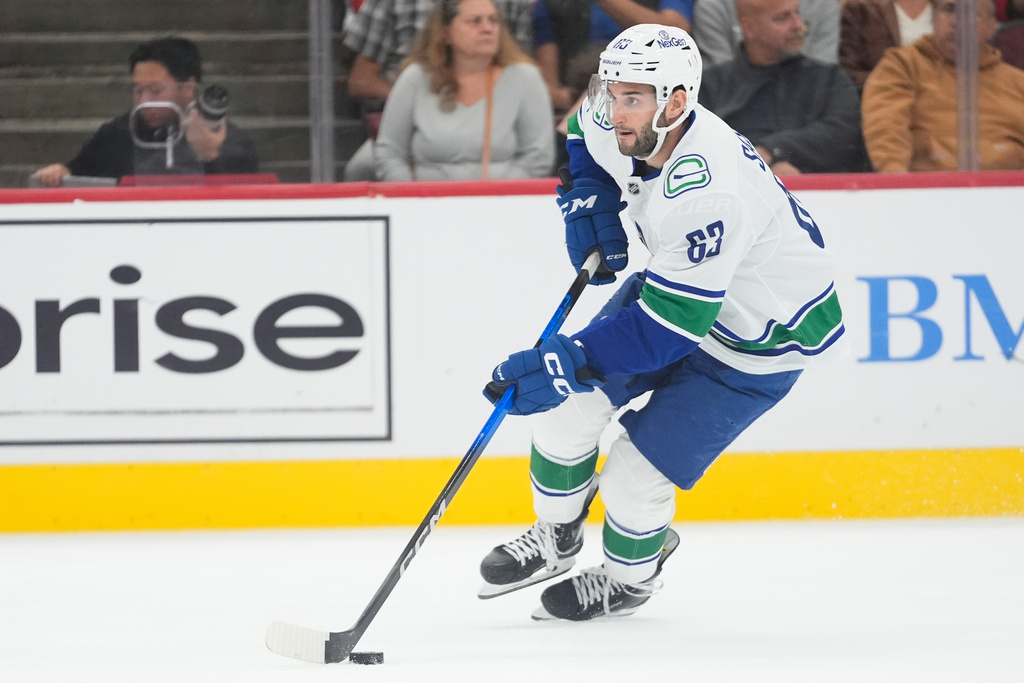 Vancouver Canucks center Max Sasson (63) handles the puck during the second period of an NHL hockey game against the Chicago Blackhawks Friday, Oct. 17, 2025, in Chicago. (AP Photo/Erin Hooley)