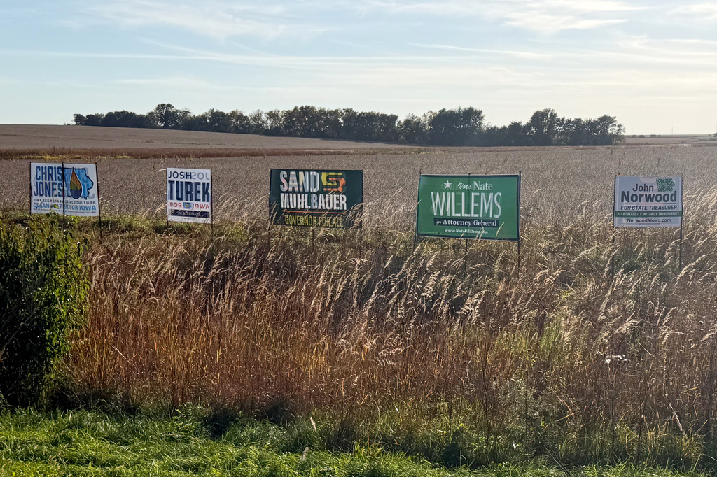 Signs supporting Democratic candidates are pictured in a field near Waterloo, Iowa, Sunday, Oct. 11, 2026. (AP Photo/Steven Sloan)