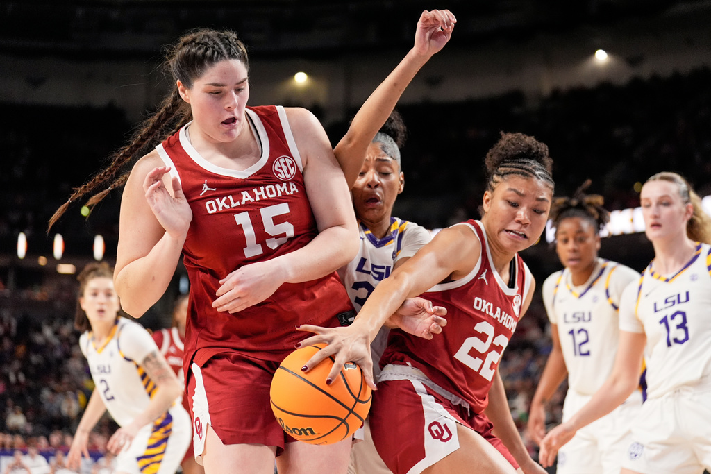 Oklahoma center Raegan Beers (15) and guard Keziah Lofton vies for the ball with LSU guard Jada Richard during first half of an NCAA college basketball game in the quarterfinals of the Southeastern Conference tournament, Friday, March 6, 2026, in Greenville, S.C. (AP Photo/Chris Carlson)