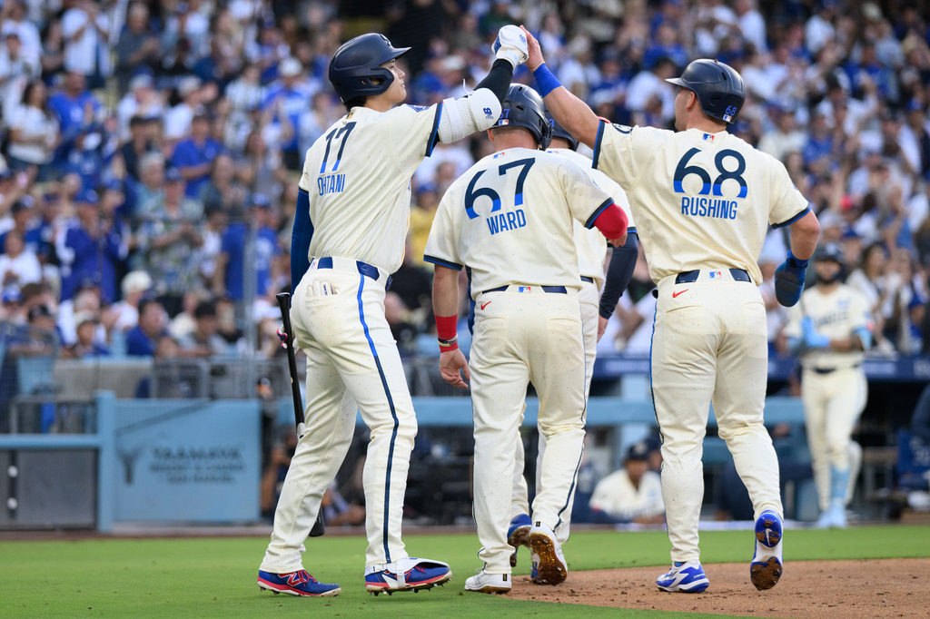 Los Angeles Dodgers' Shohei Ohtani, left, greets Dalton Rushing, right, after Rushing scores during the first inning of a baseball game against the Los Angeles Angels in Los Angeles, Saturday, June 6, 2026. (AP Photo/Kyusung Gong)