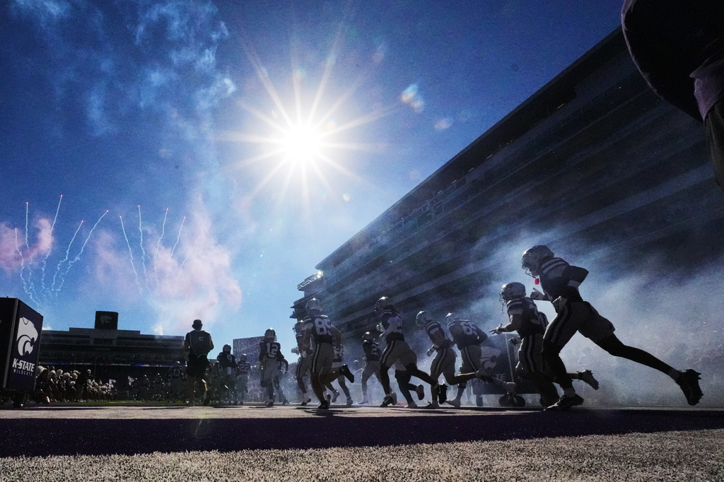 Kansas State players run onto the field before an NCAA college football game against Houston, Saturday, Oct. 10, 2026, in Manhattan, Kan. (AP Photo/Charlie Riedel)