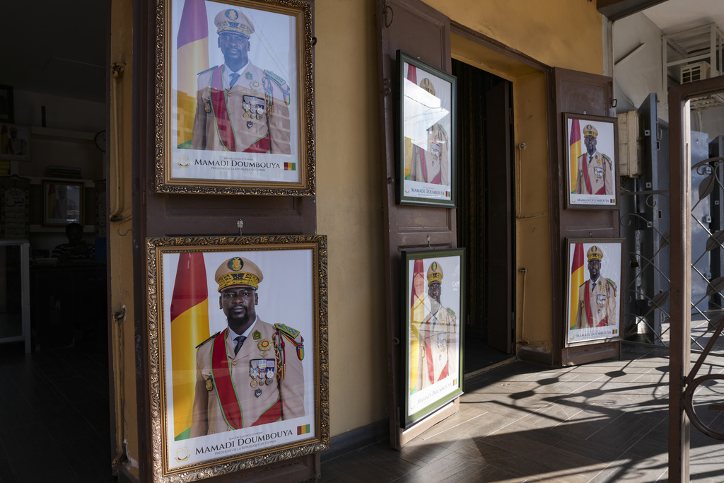 Framed portraits of Guinea's interim president, Col. Mamadi Doumbouya, are displayed side by side in Conakry, Guinea, Wednesday, Sept. 17, 2025. (AP Photo/Misper Apawu)