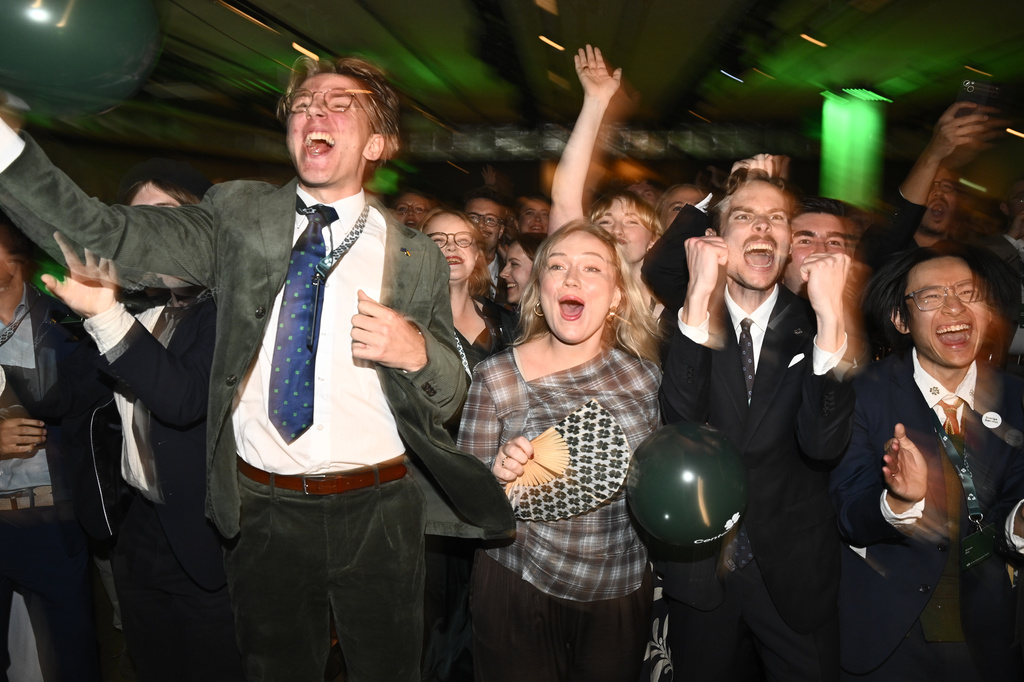 The Centre Party members react to the presentation of the exit poll at the election night watch party, in Stockholm, Sunday, Sept. 13, 2026. (Fredrik Sandberg/TT News Agency via AP)