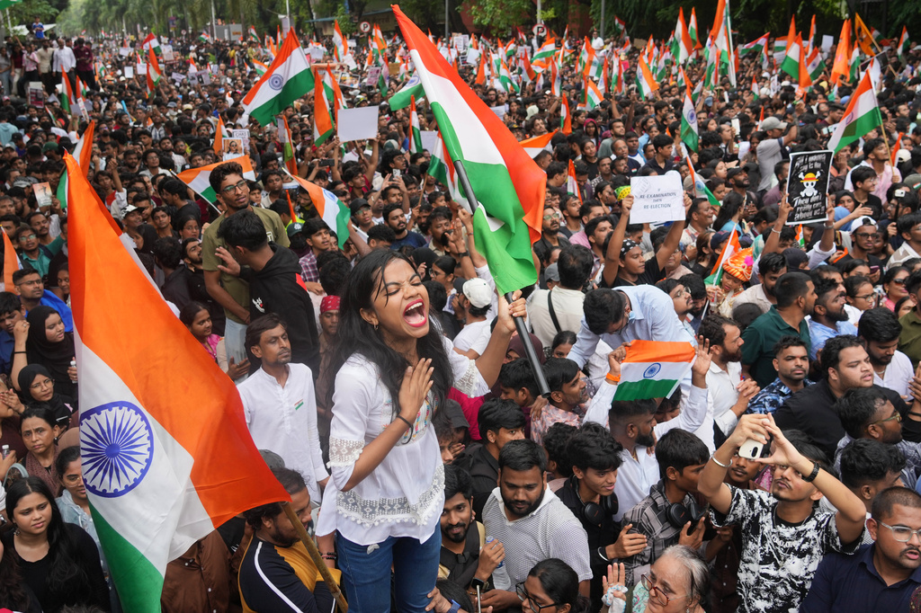 FILE- Protesters celebrate after Education Minister Dharmendra Pradhan resigned following nationwide protests as part of the Cockroach Janta Party's protest movement in Mumbai, India, Sunday, July 26, 2026. (AP Photo/Rafiq Maqbool, File)