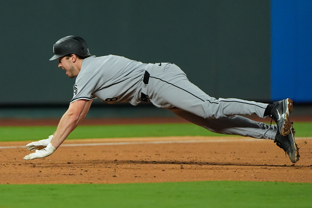 Chicago White Sox's Kyle Teel dives to third to advance on an RBI single by Miguel Vargas during the third inning of a baseball game against the Kansas City Royals, Wednesday, Sept. 23, 2026, in Kansas City, Mo. (AP Photo/Charlie Riedel)
