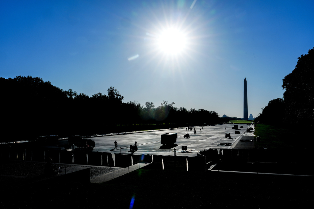 Work continues on the Lincoln Memorial Reflecting Pool after it was coated in a blue swimming pool surface ahead of the United States' 250th anniversary, Thursday, June 4, 2026, in Washington. (AP Photo/Julia Demaree Nikhinson)
