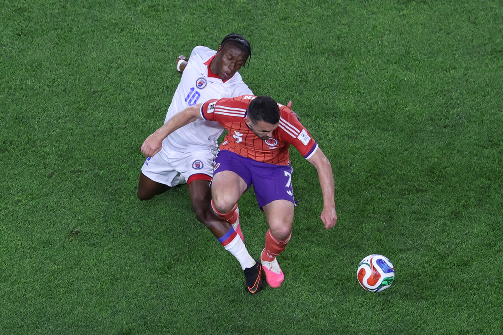 Haiti's Jean-Ricner Bellegarde (10) battles for the ball with Scotland's John McGinn (7) during the World Cup Group C soccer match between Haiti and Scotland in Foxborough, Mass., near Boston, Saturday, June 13, 2026. (AP Photo/Mark Stockwell)