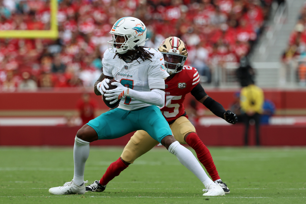 FILE - Miami Dolphins wide receiver Caleb Douglas, left, turns after making a catch as San Francisco 49ers cornerback Jack Jones (25) defends during the second half of an NFL football game in Santa Clara, Calif., Sunday, Sept. 20, 2026. (AP Photo/Jed Jacobsohn, File)