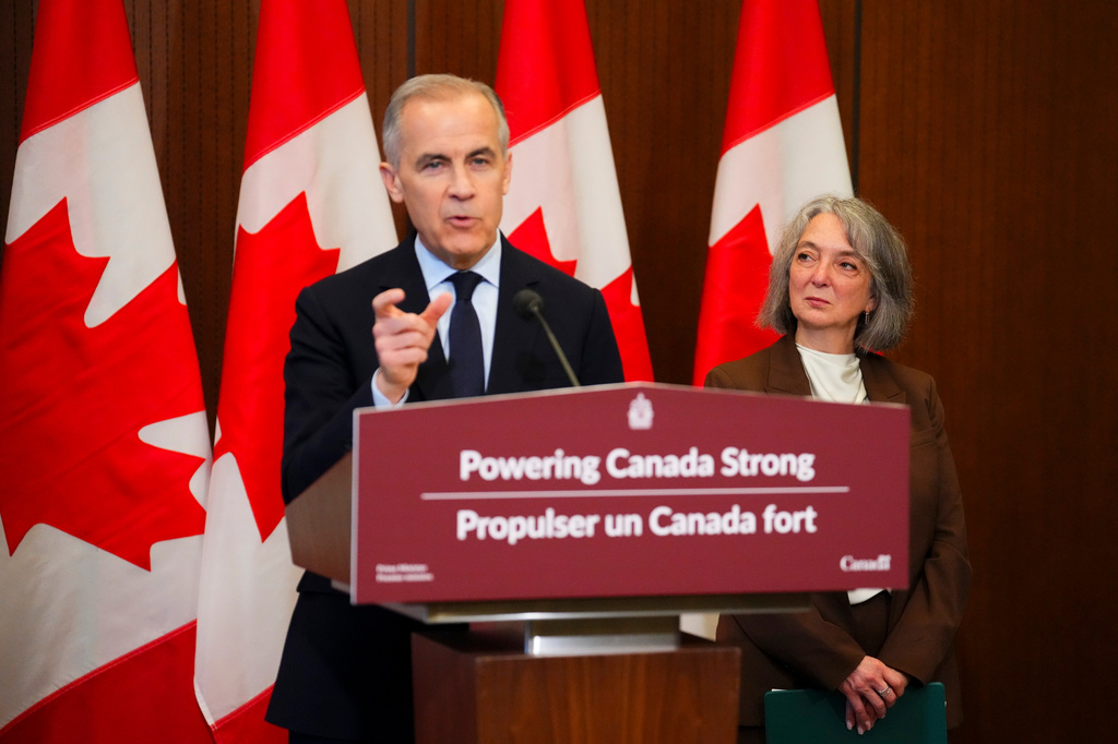 Prime Minister Mark Carney makes an announcement accompanied by Minister of Environment and Climate Change Julie Dabrusin, right, on Parliament Hill in Ottawa on Thursday, May 14, 2026. (Sean Kilpatrick/The Canadian Press via AP)