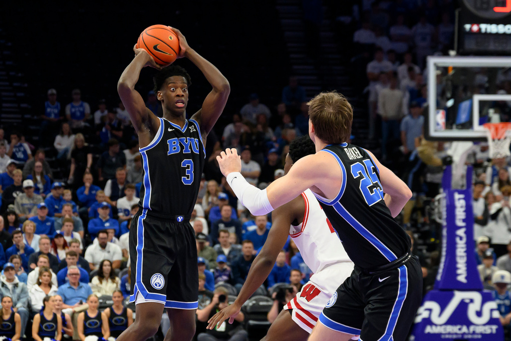 BYU forward AJ Dybantsa (3) looks to pass the ball to BYU guard Dawson Baker (25) during the first half of an NCAA college basketball game against Wisconsin, Friday, Nov. 21, 2025, in Salt Lake City. (AP Photo/Tyler Tate)