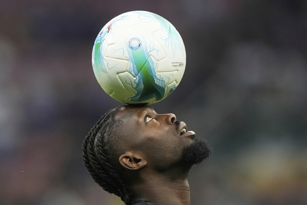 Inter Milan's Marcus Thuram controls the ball as he warms up prior to a Serie A soccer match between Inter Milan and Torino, at the San Siro stadium in Milan, Italy, Monday, Aug. 25, 2025. (AP Photo/Luca Bruno)