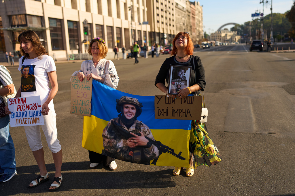 Women attend a daily nationwide minute of silence in memory of soldiers killed in the war with Russia at the Independence square in Kyiv, Ukraine, Saturday, Aug. 29, 2026, marking Ukraine's Defenders Remembrance Day. (AP Photo/Francisco Seco)