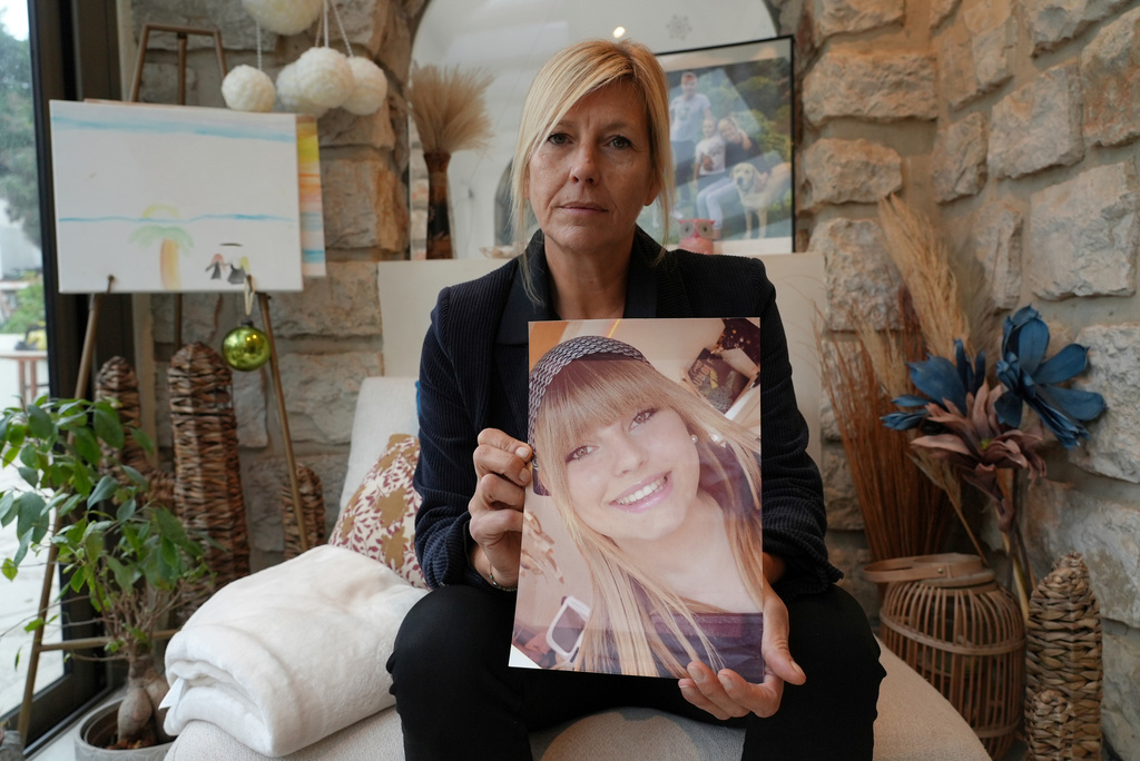 FILE - Stephanie Mistre holds a picture of her daughter, Marie Le Tiec, a teenager who died by suicide in 2021, on Dec. 10, 2024, in Cassis, France. (AP Photo/Tom Nouvian, File)