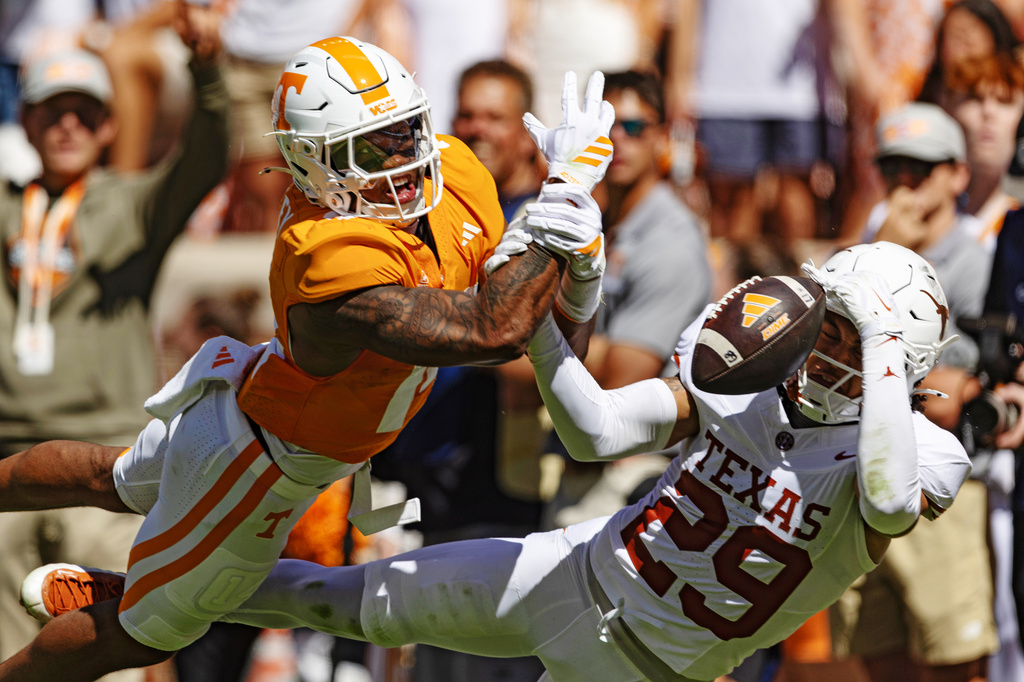 Texas defensive back Graceson Littleton (29) breaks up a pass intended for Tennessee tight end Ethan Davis (0) during the first half of an NCAA college football game, Saturday, Sept. 26, 2026, in Knoxville, Tenn. (AP Photo/Wade Payne)