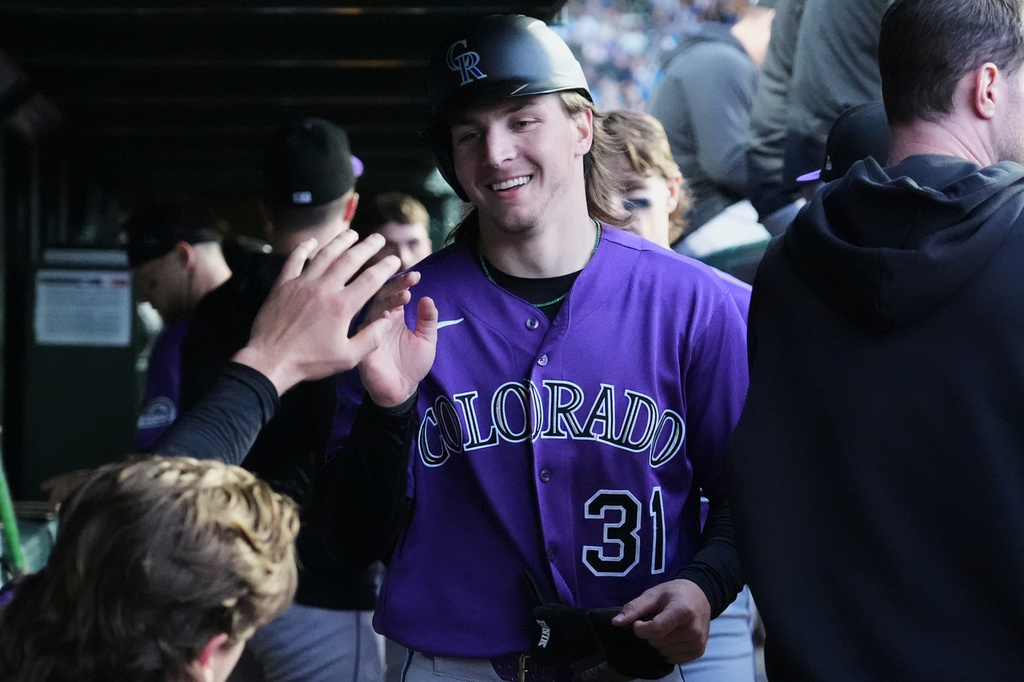 Colorado Rockies' Jake McCarthy celebrates with teammates after scoring on a one-run double by Willi Castro during the fourth inning of a baseball game against the Chicago Cubs in Chicago, Tuesday, June 16, 2026. (AP Photo/Nam Y. Huh)