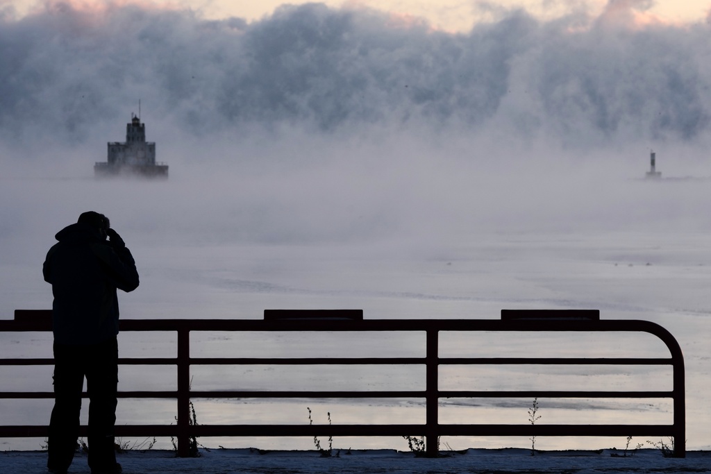 Doug Kunde watches as steam is seen over Lake Michigan as frigid temperatures for the day are not expected to reach zero degrees Friday, Jan. 23, 2026, in Milwaukee. (AP Photo/Morry Gash)