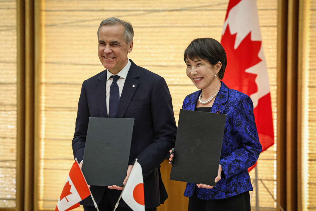 Canada's Prime Minister Mark Carney, left, and Japan's Prime Minister Sanae Takaichi take part in a signing ceremony in Tokyo, Japan, Friday, March 6, 2026. (Takashi Aoyama/Pool Photo via AP)