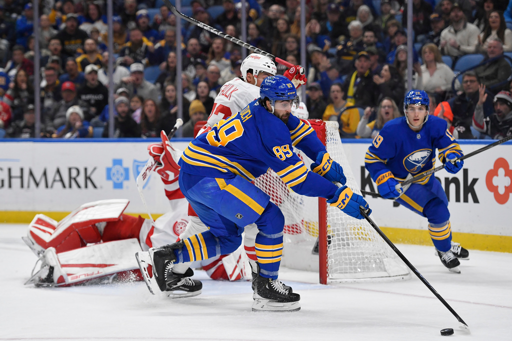 Buffalo Sabres right wing Alex Tuch (89) reaches for the puck during the first period of an NHL hockey game against the Detroit Red Wings, Friday, March 27, 2026, in Buffalo, N.Y. (AP Photo/Adrian Kraus)