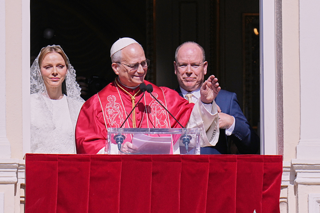 Pope Leo XIV, Princess Charlene of Monaco, and Prince Albert II of Monaco wave from the Gallery of Hercules balcony at the Prince's Palace in Monaco-Ville, Monaco, Saturday, March 28, 2026.(AP Photo/Laurent Cipriani)