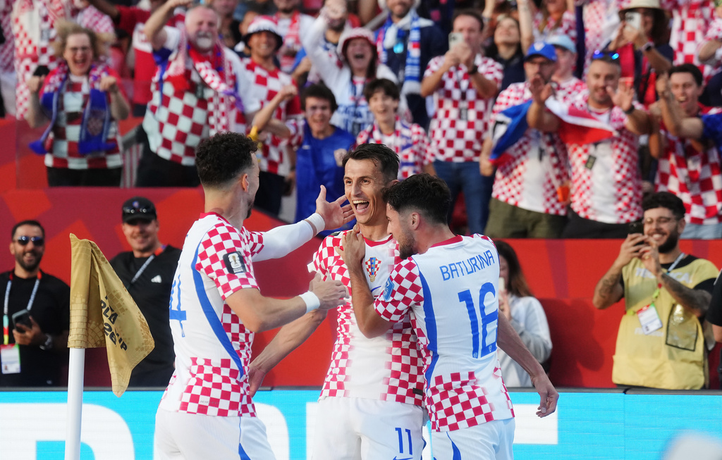 Croatia's Ante Budimir (centre) celebrates his goal against Panama with Ivan Perisic (14) and Martin Baturina (16) during the second half of a World Cup Group L soccer match, in Toronto, on Tuesday, June 23, 2026. (Nathan Denette/The Canadian Press via AP)