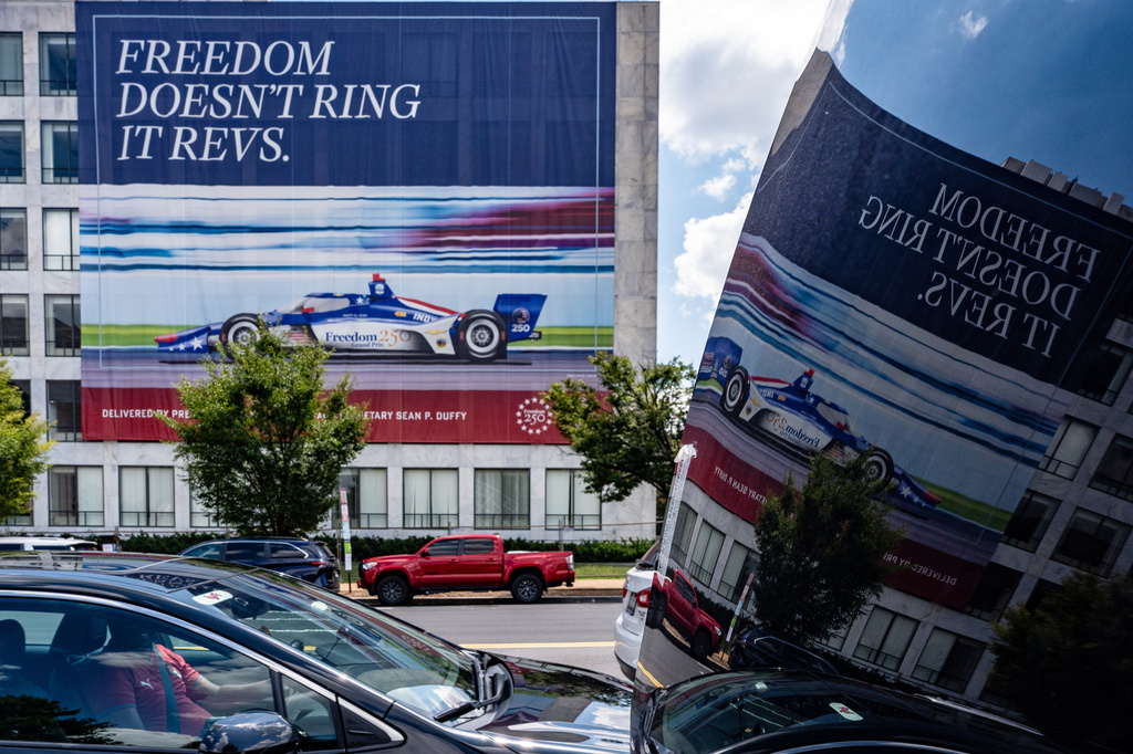 A sign on a building along the route for the upcoming Freedom 250 Grand Prix promotes the event, Friday, July 31, 2026, in Washington. (AP Photo/Alex Brandon)
