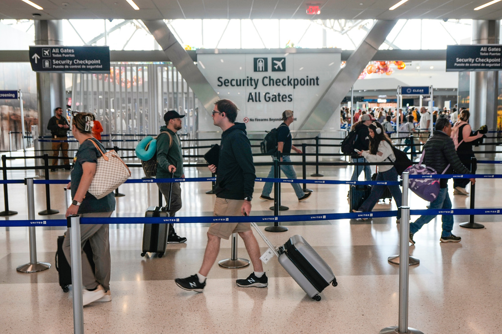 FILE - Airline passengers make their way through the security lines in Terminal E at George Bush Intercontinental Airport, in Houston, Sunday, March 29, 2026. (Brett Coomer/Houston Chronicle via AP, File)