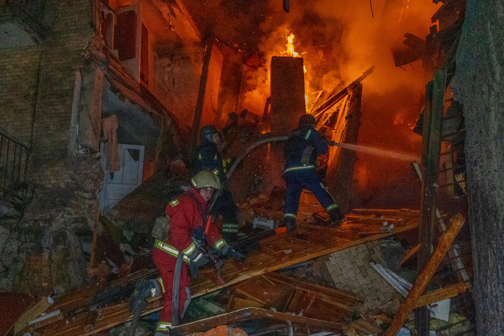 Firefighters put out a fire following a Russian air attack on a residential building in Kharkiv, Ukraine, Tuesday, Oct. 13, 2026. (AP Photo/Andrii Marienko)