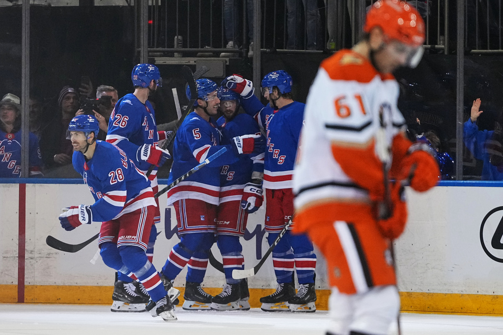New York Rangers' Oliver Bjorkstrand (28) celebrates with teammates after scoring a goal as Anaheim Ducks' Cutter Gauthier (61) skates away during the second period of an NHL hockey game Monday, Oct. 19, 2026, in New York. (AP Photo/Frank Franklin II)
