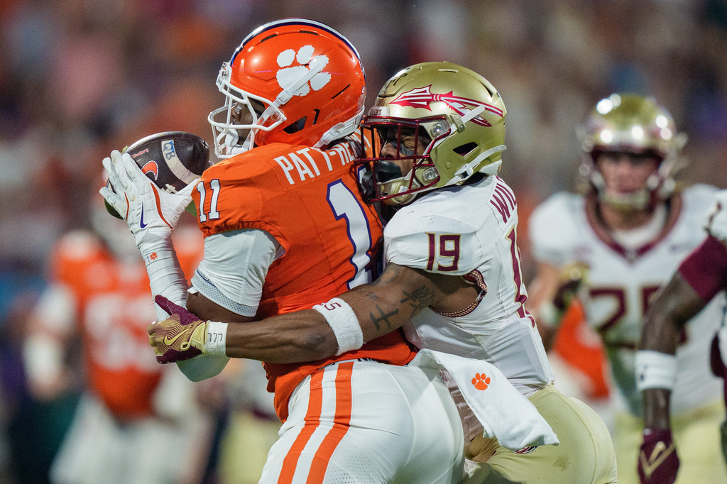 Clemson tight end Olsen Patt-Henry (11) makes a catch while covered by Florida State defensive back Jerry Wilson (19) in the first half of an NCAA college football game Saturday, Nov. 8, 2025, in Clemson, S.C. (AP Photo/Jacob Kupferman)