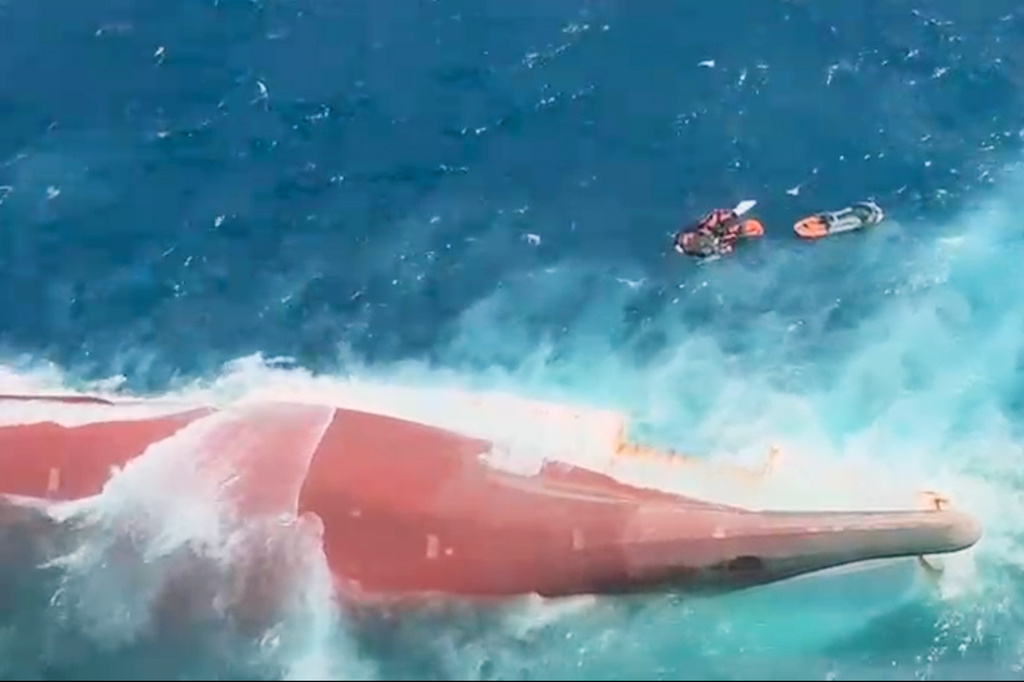 In this aerial image taken from video released by Indonesia's National Search and Rescue Agency (BASARNAS), the bottom of passenger ferry Virgo Transport 8 is seen above the water after it overturned in bad weather in the Java Sea, Sunday, Sept. 13, 2026. (BASARNAS via AP)