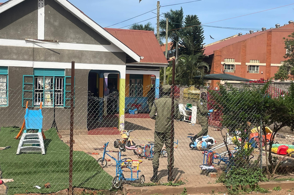 Uganda police officers stand at the crime scene after a man killed four children in a machete attack at the Gaba Early Childhood Development Program nursery school in Kampala, Uganda, Thursday, April 2, 2026. (AP Photo)