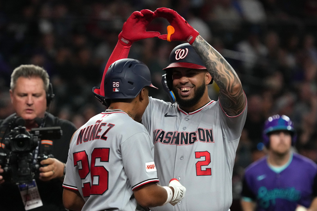 Washington Nationals' Luis García Jr. (2) celebrates with Nasim Nuñez, center left, after hitting a grand slam against the Arizona Diamondbacks in the sixth inning of a baseball game, Friday, June 5, 2026, in Phoenix. (AP Photo/Rick Scuteri)
