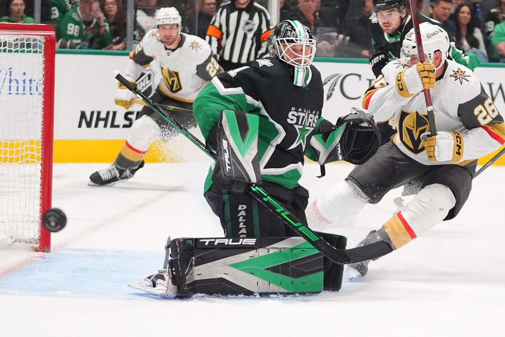 Dallas Stars goaltender Casey DeSmith (1) defends the goal against Vegas Golden Knights center Nic Dowd (26) during the second period of an NHL hockey game Sunday, March 22, 2026, in Dallas. (AP Photo/LM Otero)
