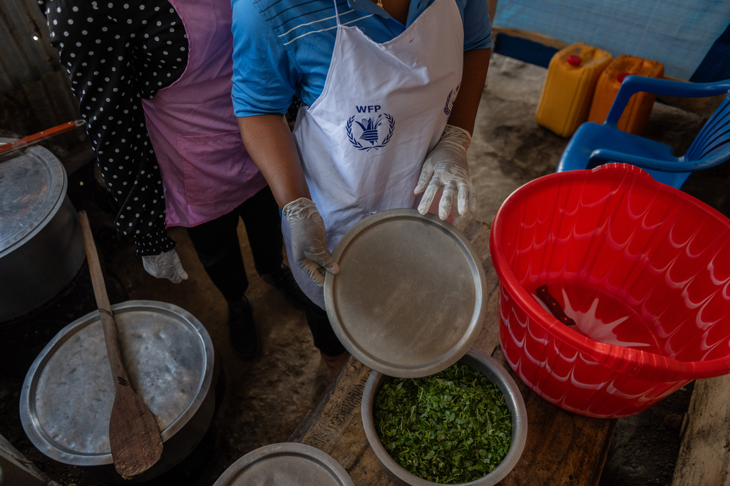 Cooks prepare meals for Ebola patients at the Evangelical Medical Center (CEM) in Bunia, Congo, Monday, June 1, 2026. (AP Photo/Moses Sawasawa)