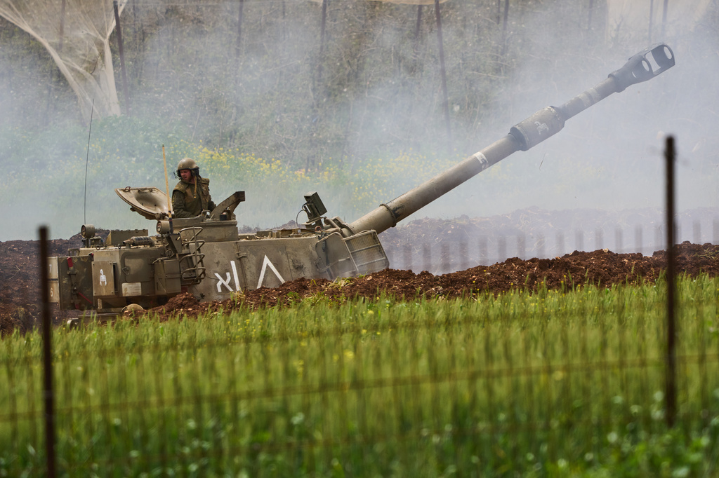 An Israeli soldier stands atop an artillery unit as it fires toward southern Lebanon from northern Israel, Wednesday, April 15, 2026. (AP Photo/Ariel Schalit)
