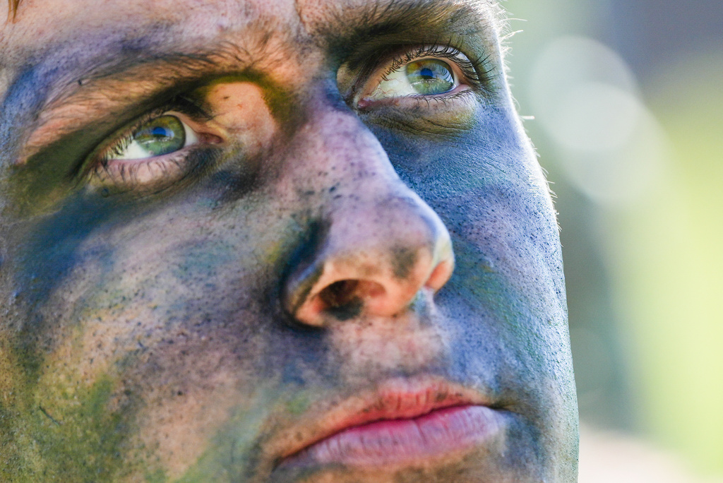 A cadet applies camouflage face paint before competing in the grenade assault course during the Sandhurst Military Skills Competition at the United States Military Academy in West Point, N.Y., Friday, May 1, 2026. (AP Photo/Julia Demaree Nikhinson)