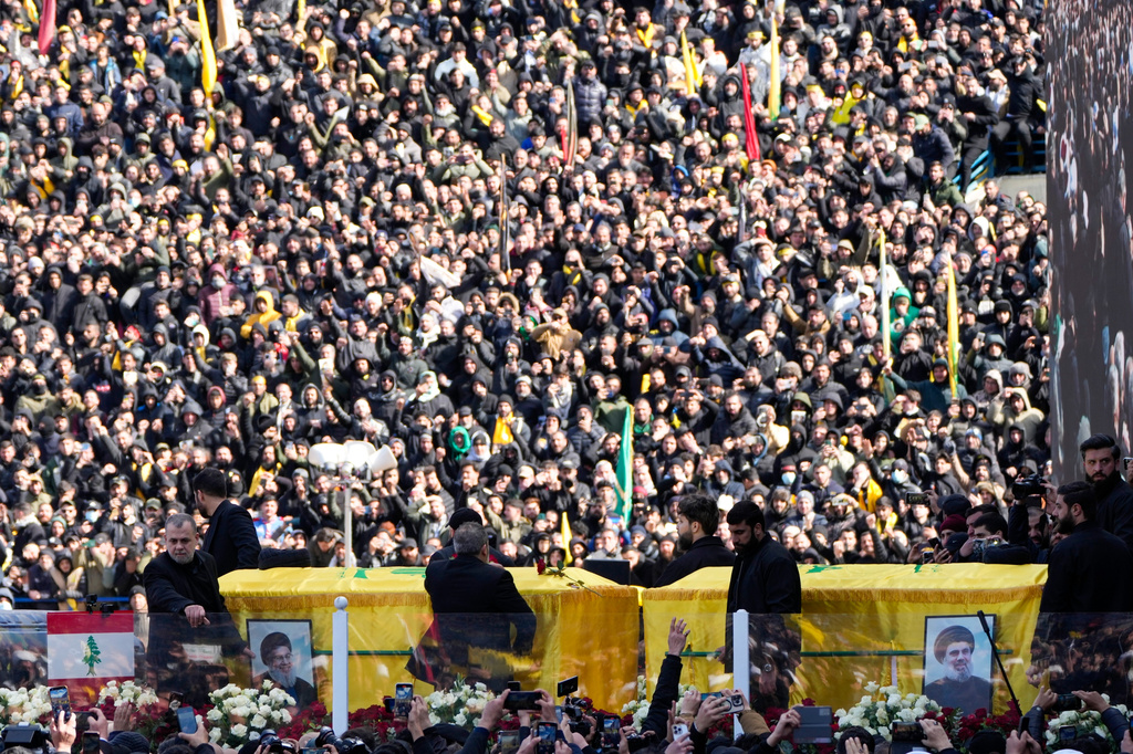 FILE - A trailer carrying the coffins containing the bodies of Hezbollah's former leader Hassan Nasrallah and his cousin and successor Hashem Safieddine drives through the crowd at the beginning of a funeral procession in the Sports City Stadium in Beirut, Sunday, Feb. 23, 2025. (AP Photo/Hussein Malla, File)