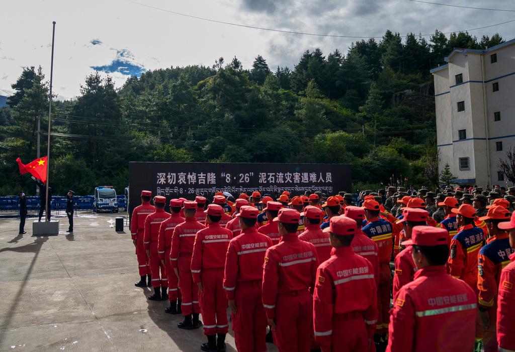 In this photo released by Xinhua News Agency, rescuers attend a memorial service for the victims of the Aug. 26 mudslide at the Xigaze Public Security Bureau in Gyirong County, southwestern China's Tibet Autonomous Region, Tuesday, Sept. 1, 2026. (Tenzin Nyida/Xinhua via AP)