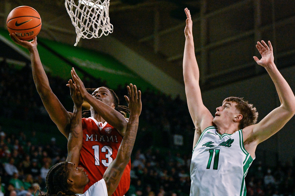 CORRECTS TO WOOLFOLK, NOT WOOLFOLF - Miami (Ohio) Forward Antwone Woolfolk (13) drives to the basket during the first half of an NCAA college Basketball game, Saturday, Feb. 7, 2026, in Huntington, W.Va. (AP Photo/Tyler Evert)