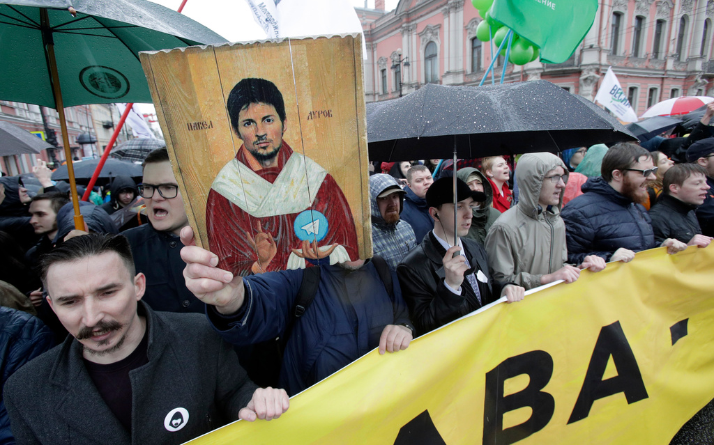 FILE - Protesters hold a portrait of messaging app Telegram co-founder Pavel Durov designed as an icon, protesting against the blocking of the app in Russia, during a May Day rally in St. Petersburg, Russia, Tuesday, May 1, 2018. (AP Photo, File)