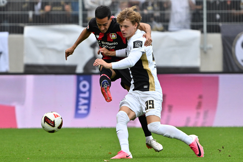 Elversberg's Cole Campbell, right, vies for the ball with Bayer Leverkusen's Lucas Vazques during a Bundesliga soccer match between Elversberg and Bayer Leverkusen, in Spiesen-Elversberg, Germany, Saturday, Aug. 29, 2026. (Harald Tittel/dpa via AP)
