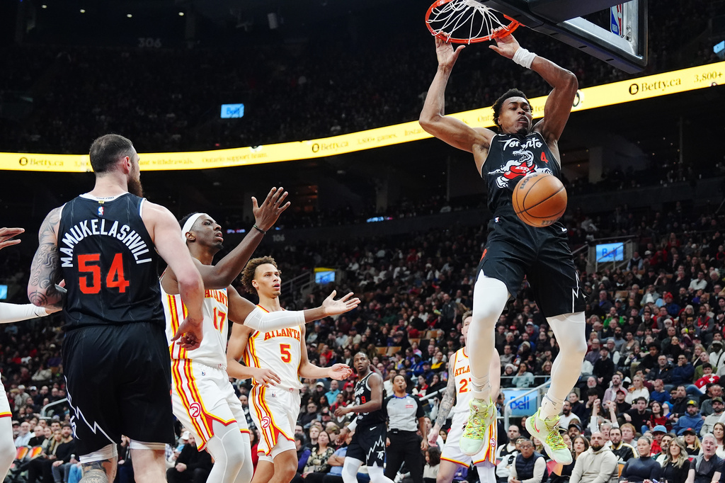Toronto Raptors' Scottie Barnes (4) dunks against the Atlanta Hawks during the first half of an NBA basketball game in Toronto, Saturday, Jan. 3, 2026. (Frank Gunn/The Canadian Press via AP)