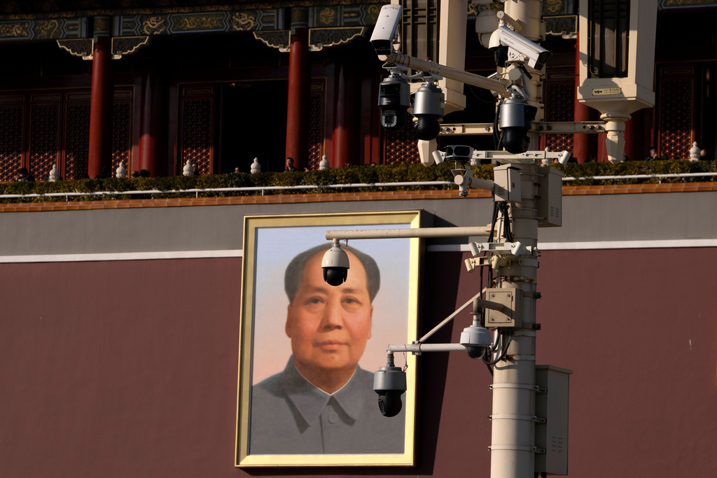 A portrait of late paramount leader Mao Zedong is seen behind security cameras near Tiananmen Gate in Beijing, Tuesday, Feb. 18, 2025. (AP Photo/Ng Han Guan)