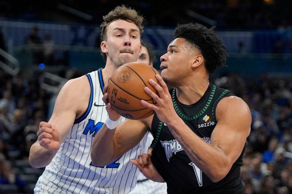 Minnesota Timberwolves guard Terrence Shannon Jr., right, goes to the basket against Orlando Magic forward Franz Wagner, left, during the first half of an NBA basketball game, Wednesday, April 8, 2026, in Orlando, Fla. (AP Photo/John Raoux)
