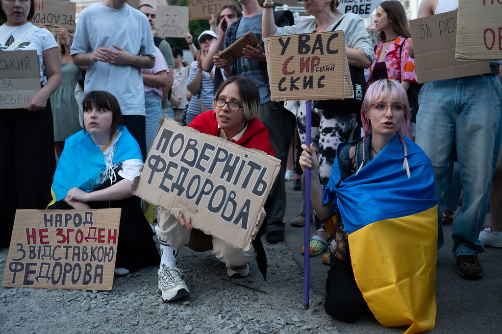 People gather to denounce President Volodymyr Zelenskyy's decision to dismiss Defense Minister Mykhailo Fedorov after six months in the post, Thursday, July 16, 2026, Kyiv, Ukraine. Placard reads "Bring back Fedorov. Do not destroy defense capability." (AP Photo/Danylo Antoniuk)