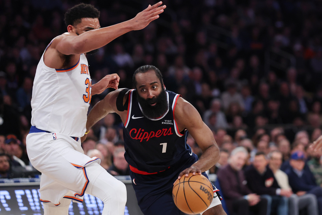 LA Clippers guard James Harden (1) drives to the basket past New York Knicks center Karl-Anthony Towns during the first half of an NBA basketball game, Wednesday, Jan. 7, 2026, in New York. (AP Photo/Heather Khalifa)