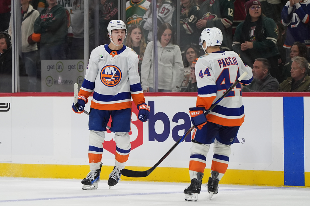 New York Islanders defenseman Matthew Schaefer, left, celebrates next to center Jean-Gabriel Pageau (44) after scoring the winning goal during overtime of an NHL hockey game against the Minnesota Wild, Thursday, Oct. 29, 2026, in St. Paul, Minn. (AP Photo/Abbie Parr)