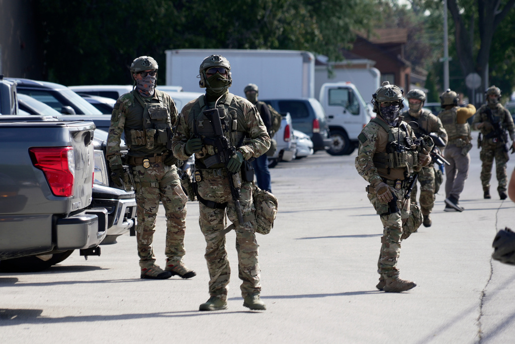 Federal agents stand guard as a planned protest starts outside of an immigration facility in Broadview, Ill. Friday, Sept. 12, 2025. (AP Photo/Laura Bargfeld)